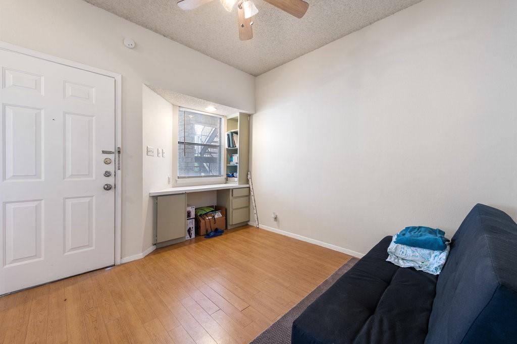 2604 Salado Street, Unit 302 Austin, TX 78705 - Photo 4 of 15 a bed room with a bed and a chandelier