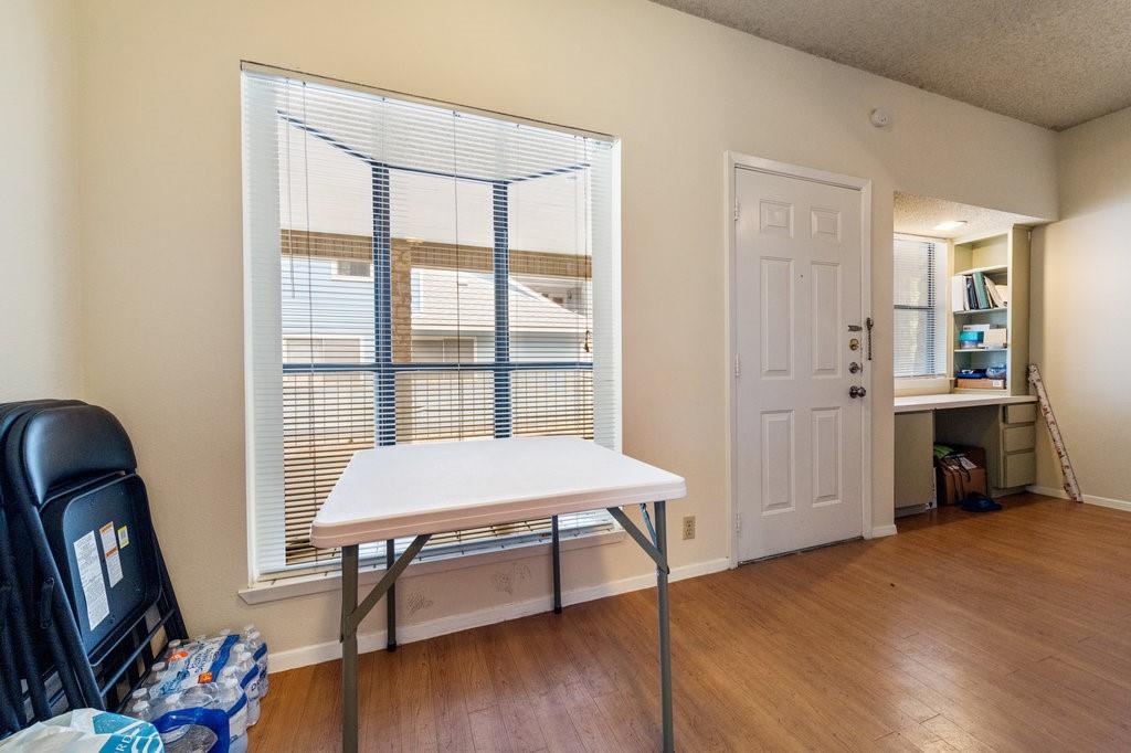 2604 Salado Street, Unit 302 Austin, TX 78705 - Photo 7 of 15 a room that has a bed and a table in it