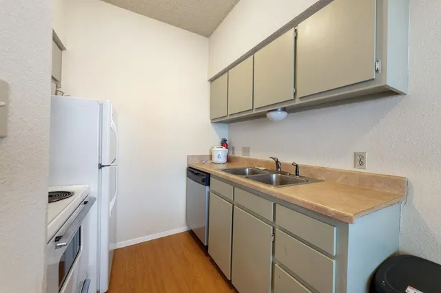 a kitchen with a stove and a refrigerator