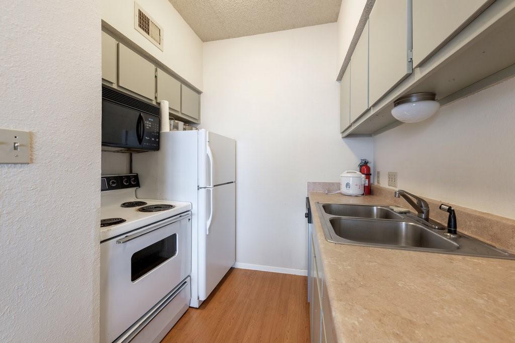 2604 Salado Street, Unit 302 Austin, TX 78705 - Photo 9 of 15 a kitchen with a stove and a refrigerator