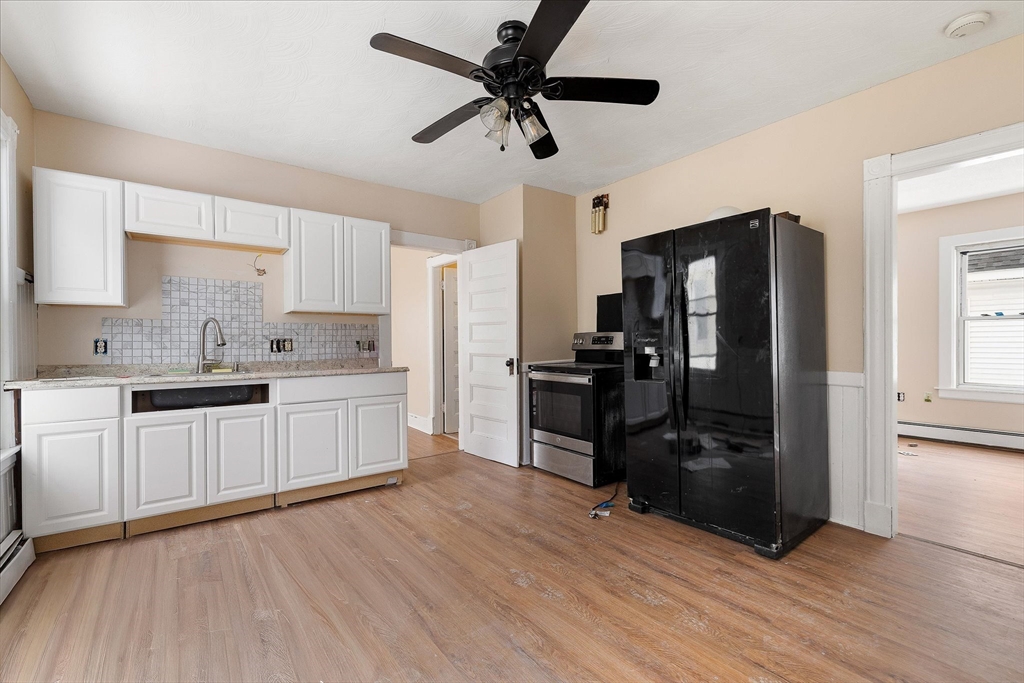 189-191 Northampton Avenue Springfield, MA 01109 - Photo 14 of 39 a kitchen with a refrigerator and white cabinets
