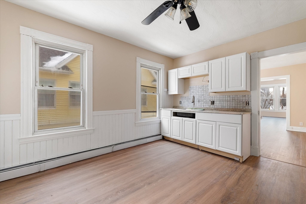 189-191 Northampton Avenue Springfield, MA 01109 - Photo 15 of 39 a kitchen with granite countertop white cabinets and window