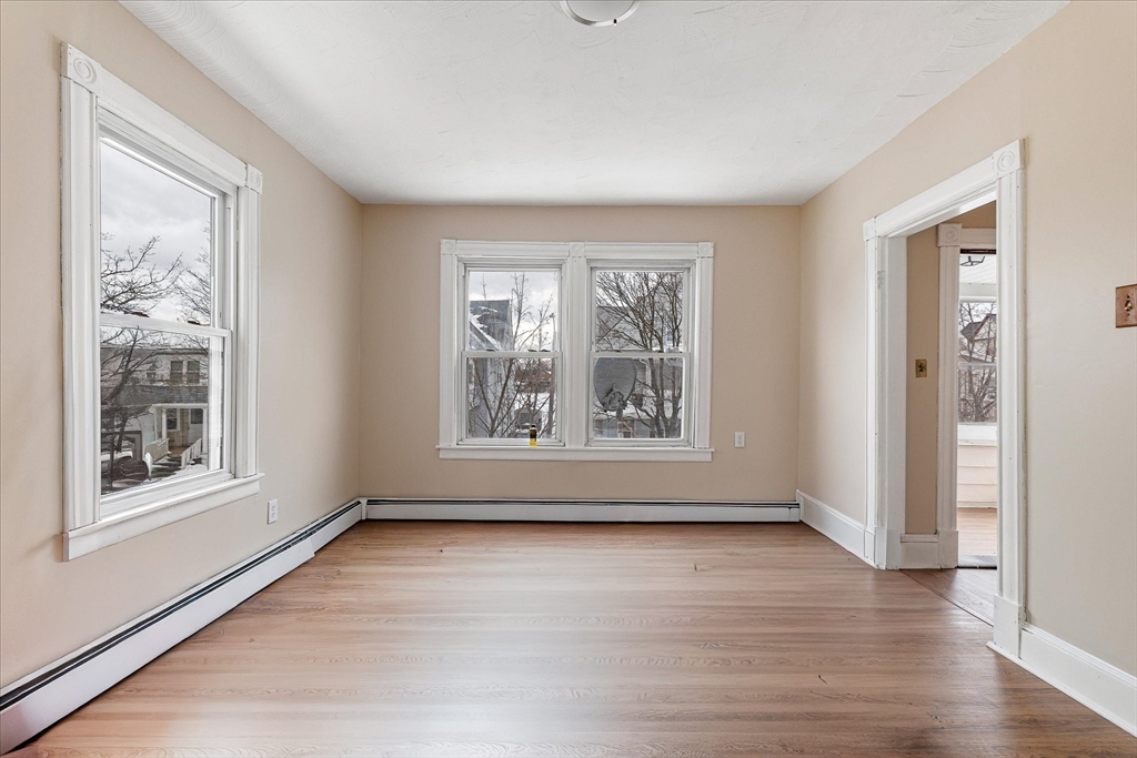 189-191 Northampton Avenue Springfield, MA 01109 - Photo 22 of 39 a view of an empty room with wooden floor and a window
