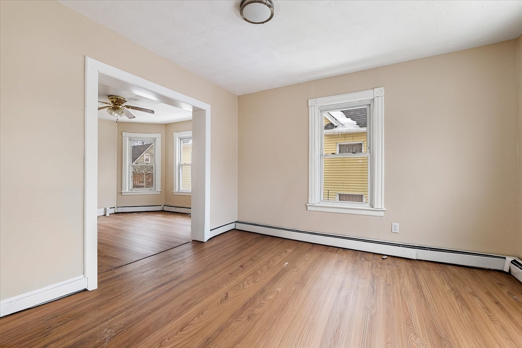 189-191 Northampton Avenue Springfield, MA 01109 - Photo 23 of 39 an empty room with wooden floor and windows