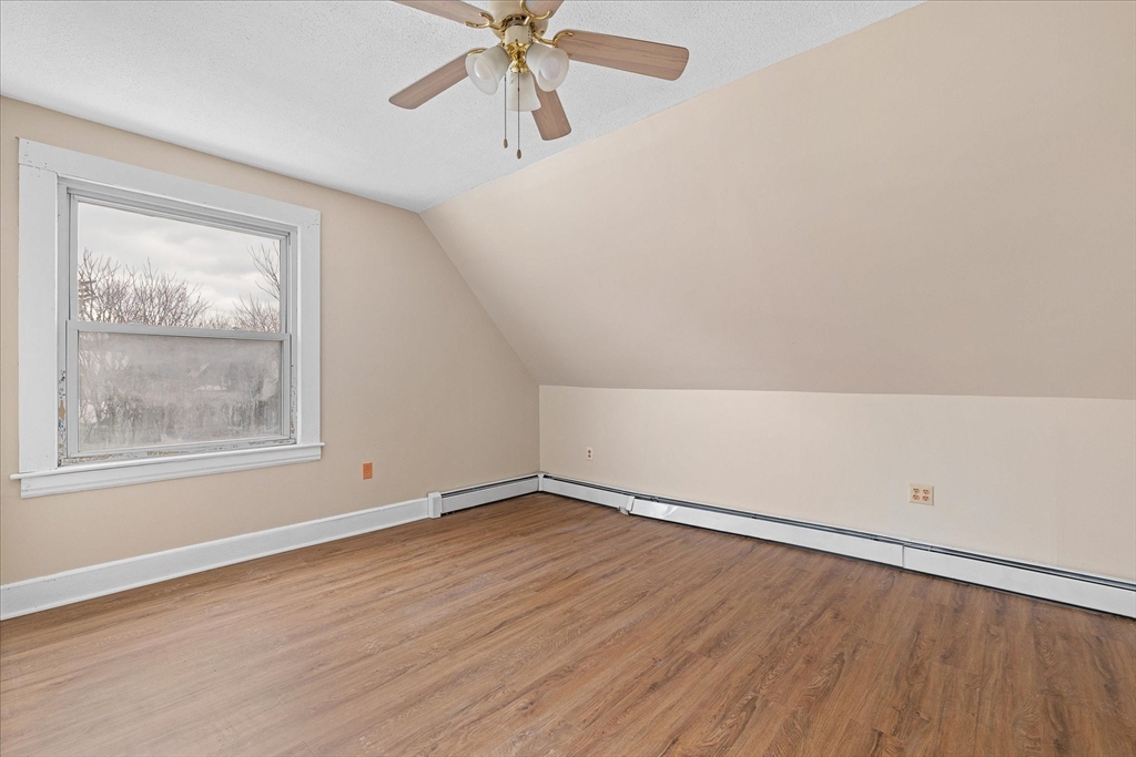 189-191 Northampton Avenue Springfield, MA 01109 - Photo 26 of 39 an empty room with wooden floor chandelier fan and windows