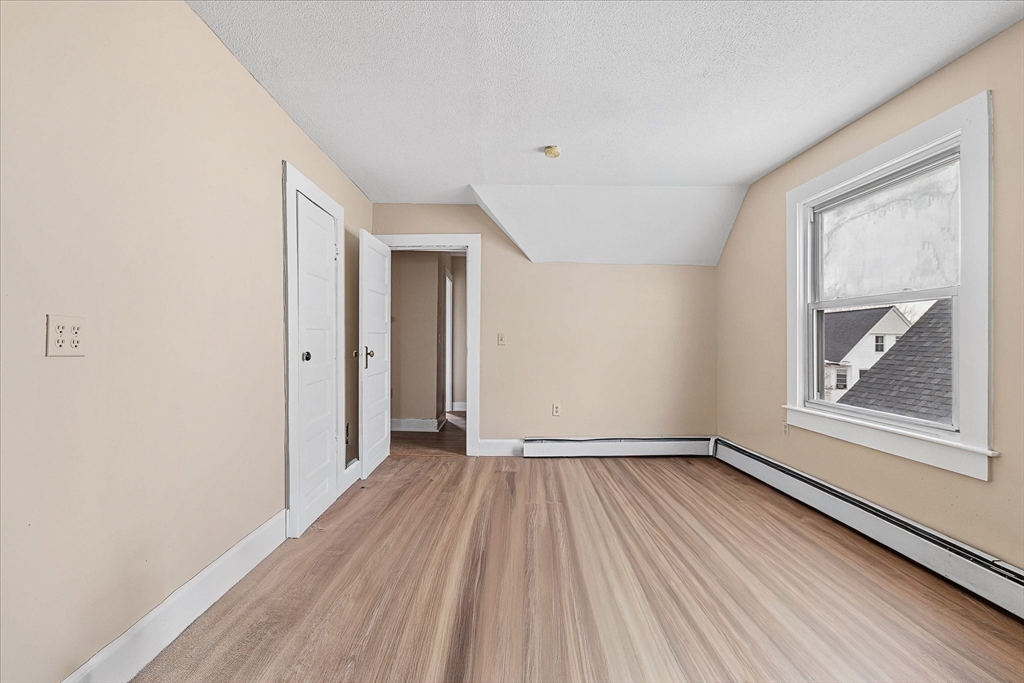 189-191 Northampton Avenue Springfield, MA 01109 - Photo 27 of 39 a view of an empty room with wooden floor and a window