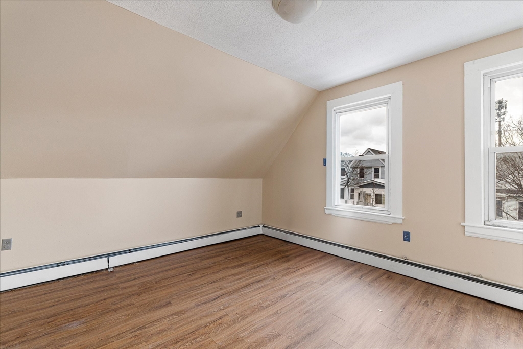 189-191 Northampton Avenue Springfield, MA 01109 - Photo 29 of 39 an empty room with wooden floor and windows