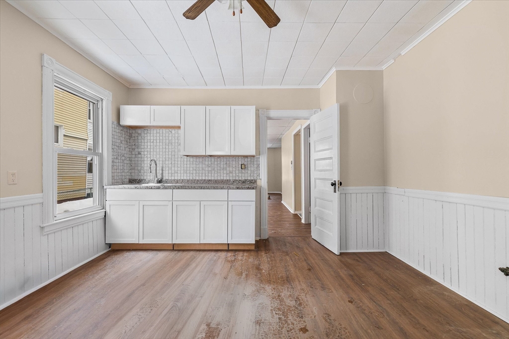 189-191 Northampton Avenue Springfield, MA 01109 - Photo 5 of 39 a kitchen with wooden floors and white cabinets