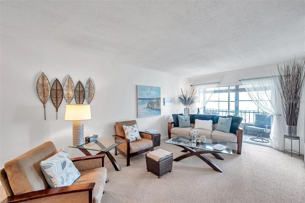 1430 Heather Ridge Boulevard, Unit 304 Dunedin, FL 34698 - Photo 12 of 36 a living room with furniture and a window