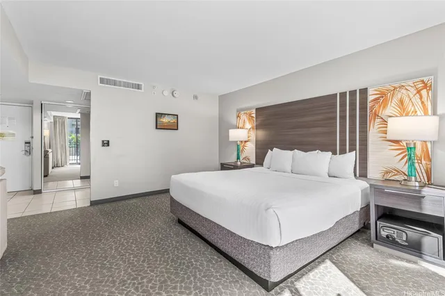 a large white bed in a white room