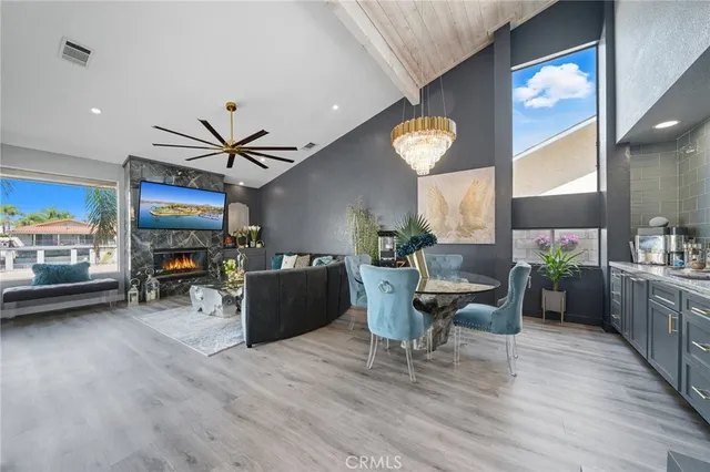 a living room with furniture a ceiling fan and a large window
