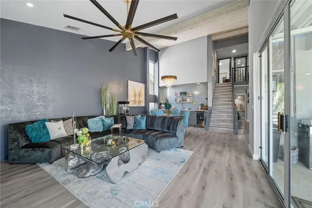 a view of a hallway with wooden floor and stairs