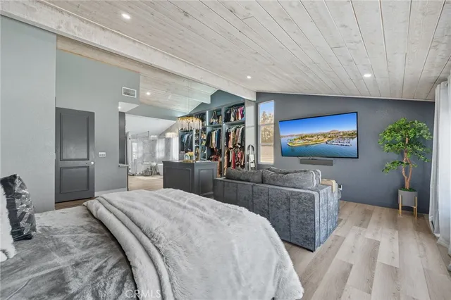 a bedroom with a bed and a painting on the wall