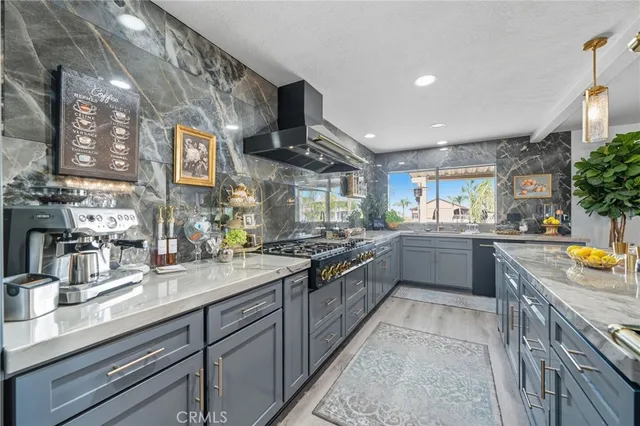 a kitchen with a stove and a wooden floor