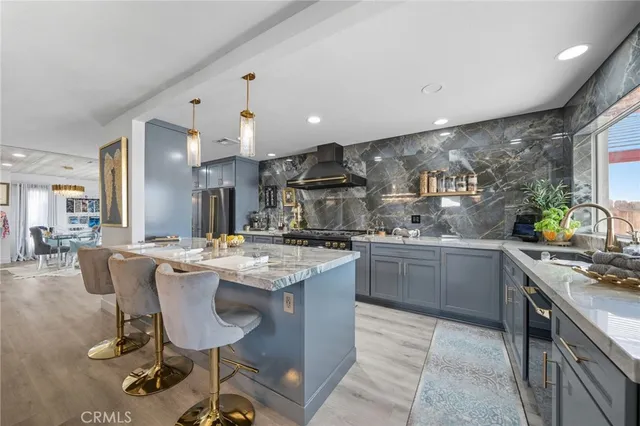a view of a kitchen with a sink and stainless steel appliances
