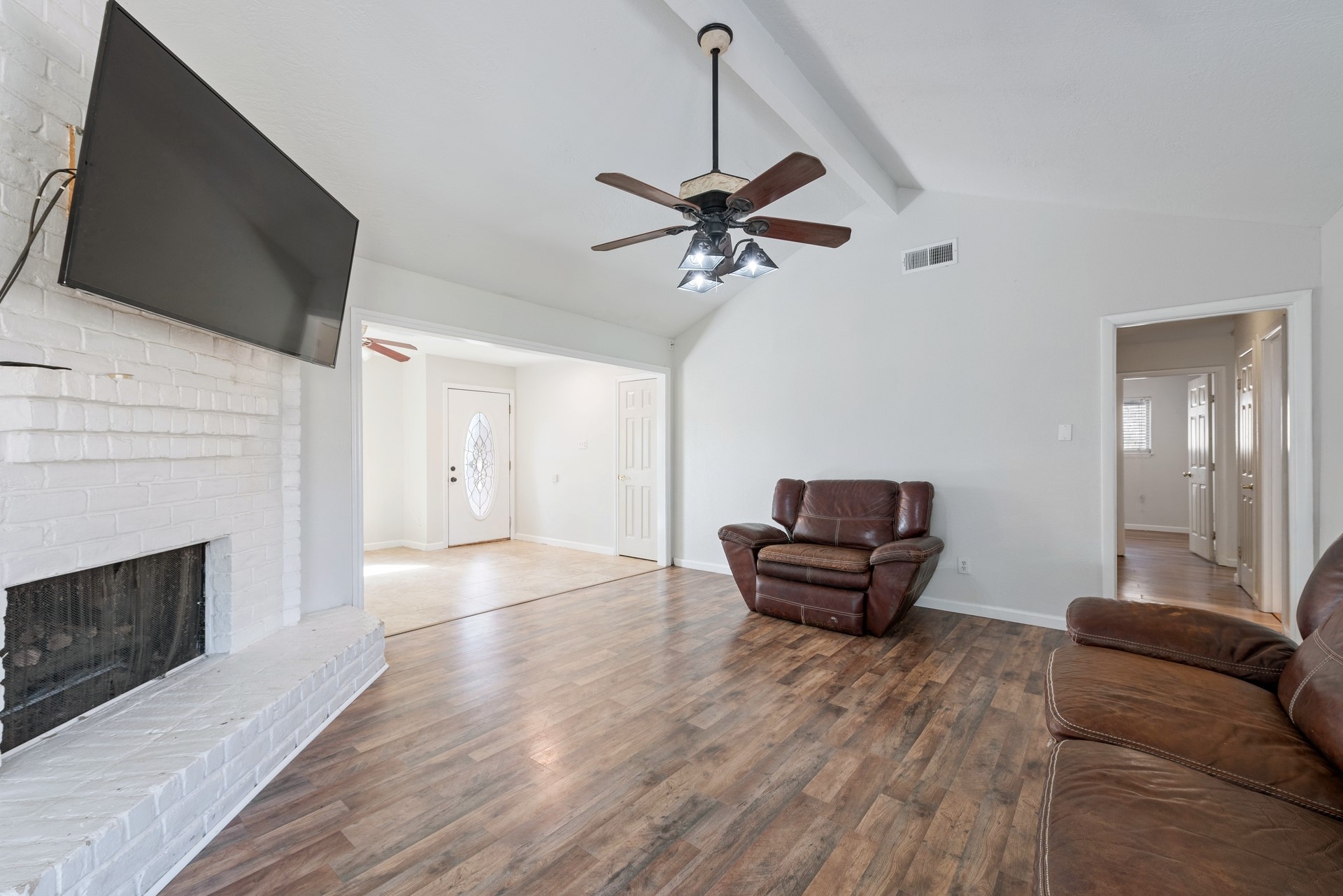 9622 Birsay Street Spring, TX 77379 - Photo 6 of 17 Back living area has vaulted ceilings and wood floors plus the hallway to the four bedrooms.