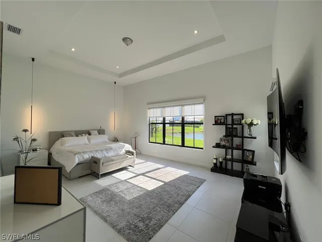 a spacious bedroom with a bed and a couch