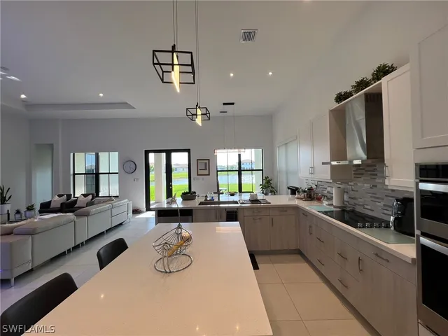 a large kitchen with a large window and stainless steel appliances