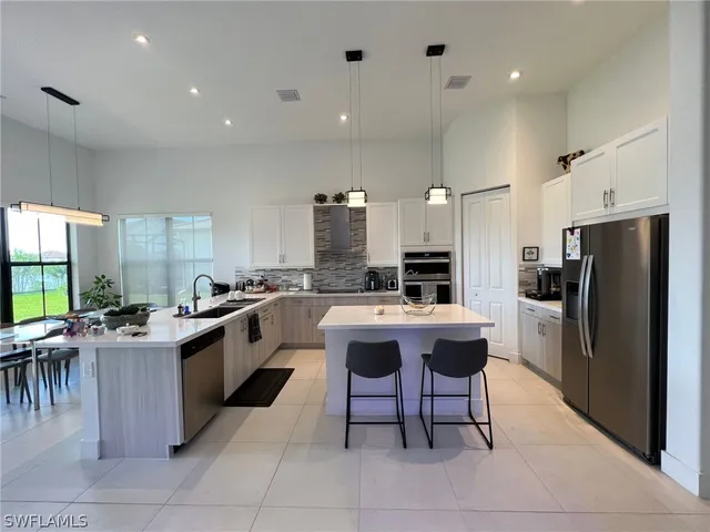 a large kitchen with a table and chairs