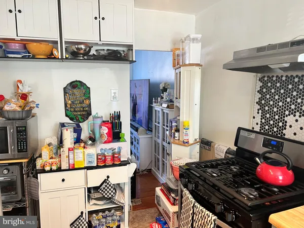 a kitchen with stainless steel appliances granite countertop a stove and cabinets