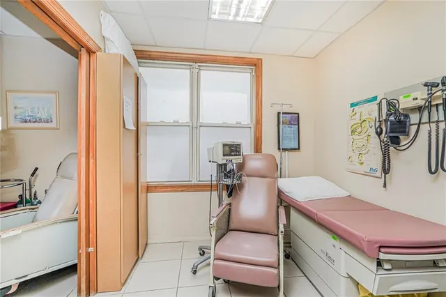 a living room with furniture a flat screen tv and a window