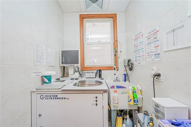 a utility room with a sink dryer and washer