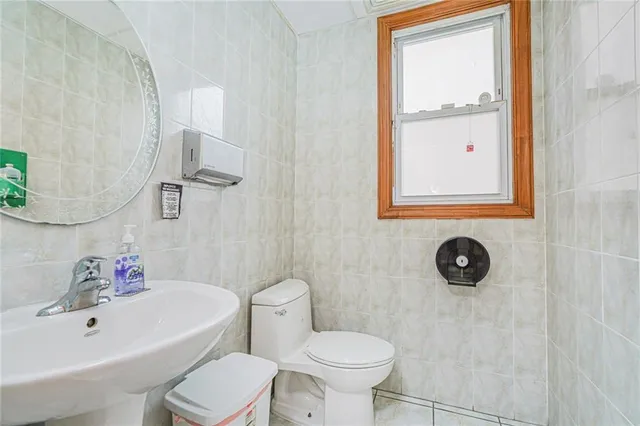 a bathroom with a sink mirror toilet and bathtub