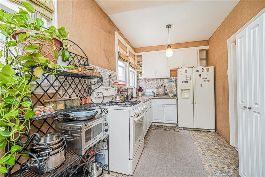 237 Bay Ridge Parkway Brooklyn, NY 11209 - Photo 22 of 30 a kitchen with a sink stove and refrigerator