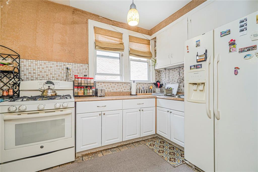 237 Bay Ridge Parkway Brooklyn, NY 11209 - Photo 23 of 30 a kitchen with white cabinets and white appliances