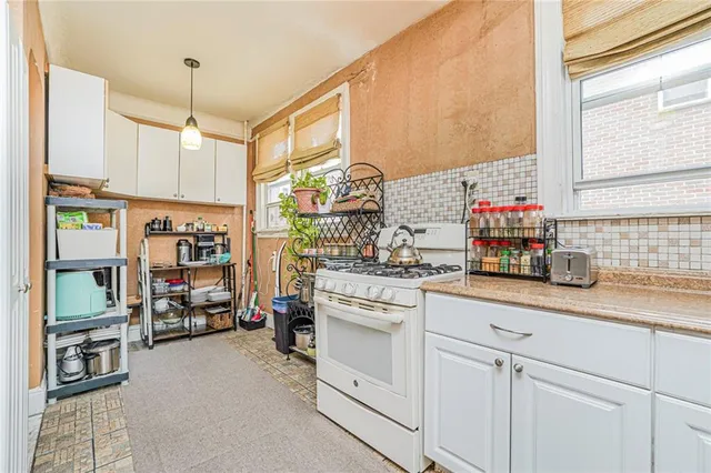 a kitchen with cabinets and window