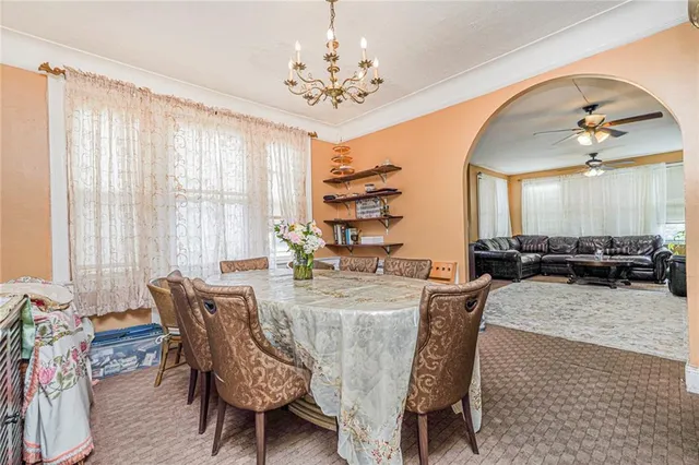 a view of a dining room with furniture and chandelier