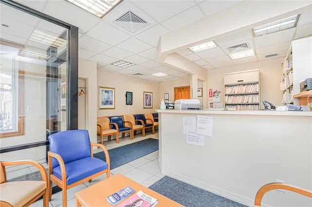 a living room with furniture wooden floor and a large window