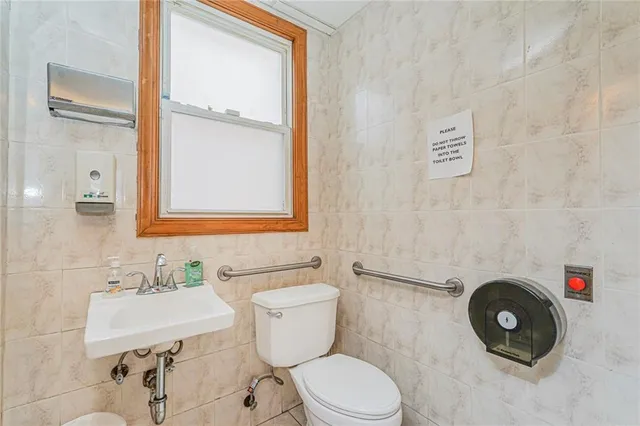 a bathroom with a sink a toilet and a mirror