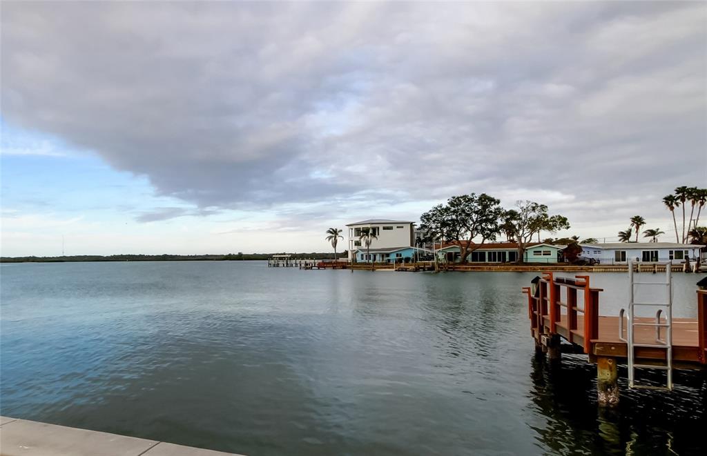 16113 4th Street East Redington Beach, FL 33708 - Photo 1 of 1 a view of a lake with boats and trees in the background