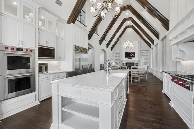 a kitchen with stainless steel appliances a stove microwave and a sink