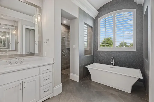 a bathroom with a sink a mirror and a bathtub