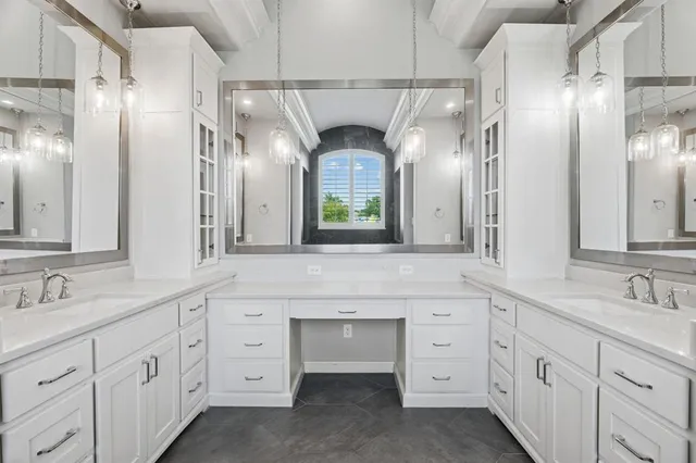 a bathroom with a double vanity sink and a mirror