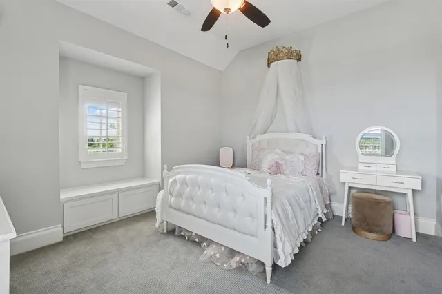 a spacious bedroom with a bed and a chandelier