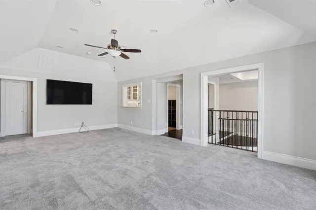 a view of an empty room with a ceiling fan
