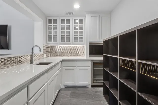a kitchen with a sink and cabinets