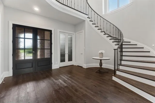 a view of staircase with wooden floor and a rug