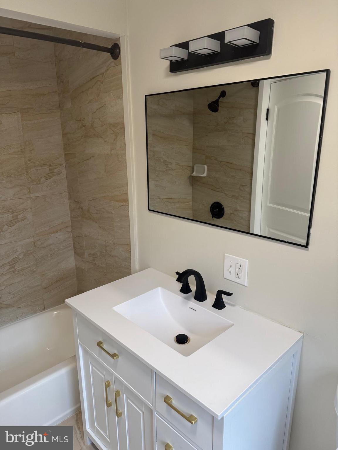 334 Church Road, Unit 2 Elkins Park, PA 19027 - Photo 12 of 38 a bathroom with a sink and a mirror