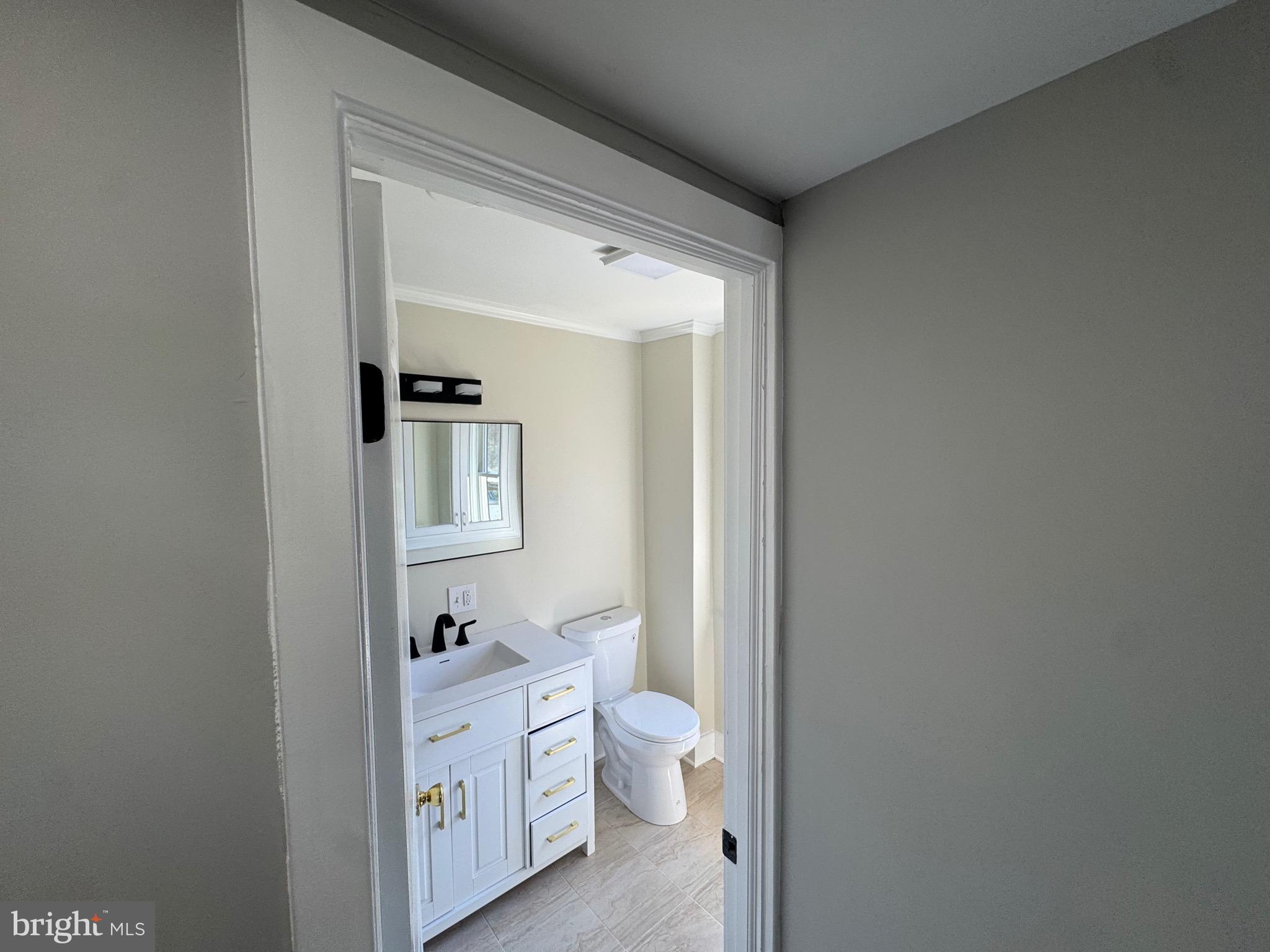 334 Church Road, Unit 2 Elkins Park, PA 19027 - Photo 25 of 38 a bathroom with a toilet a sink and mirror