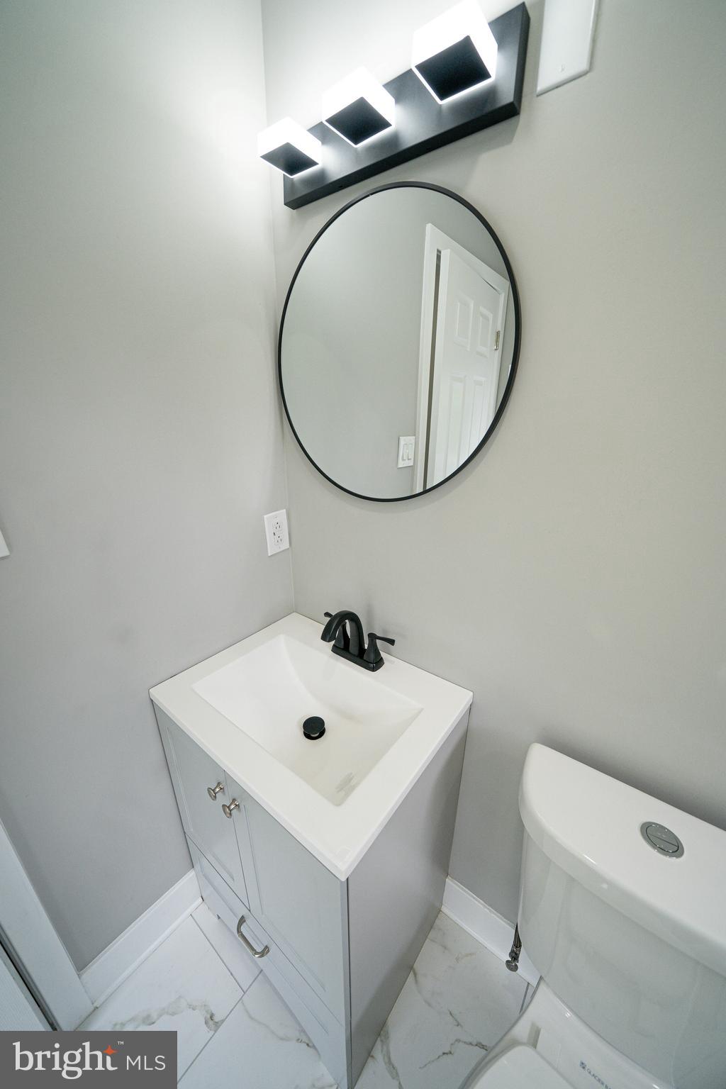 334 Church Road, Unit 2 Elkins Park, PA 19027 - Photo 27 of 38 a bathroom with a sink a toilet and a mirror