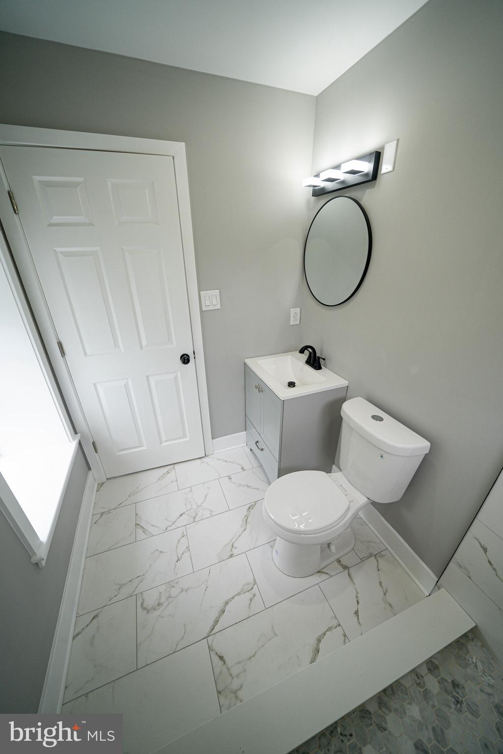 334 Church Road, Unit 2 Elkins Park, PA 19027 - Photo 28 of 38 a bathroom with a sink mirror toilet and a mirror