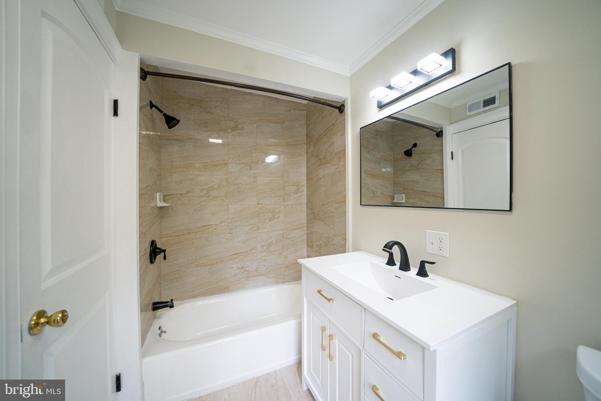 334 Church Road, Unit 2 Elkins Park, PA 19027 - Photo 5 of 38 a bathroom with a bathtub shower sink and mirror