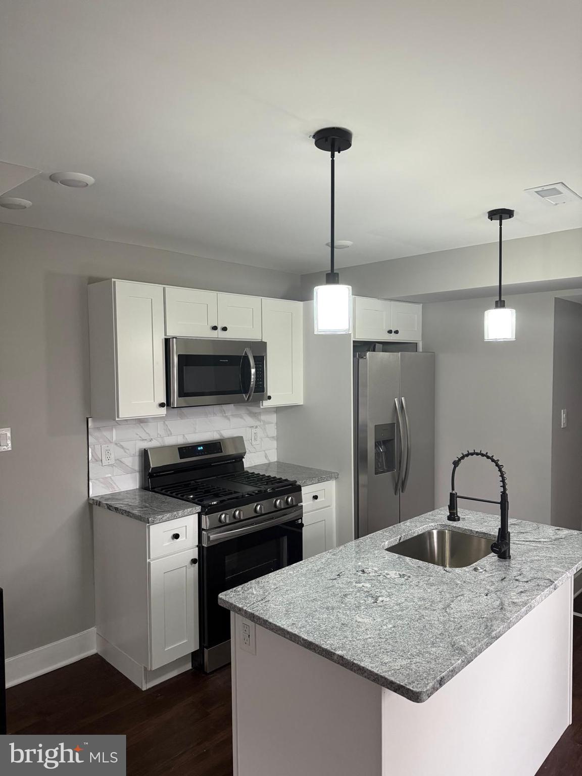 334 Church Road, Unit 2 Elkins Park, PA 19027 - Photo 8 of 38 a kitchen with stainless steel appliances granite countertop a sink a stove and a refrigerator