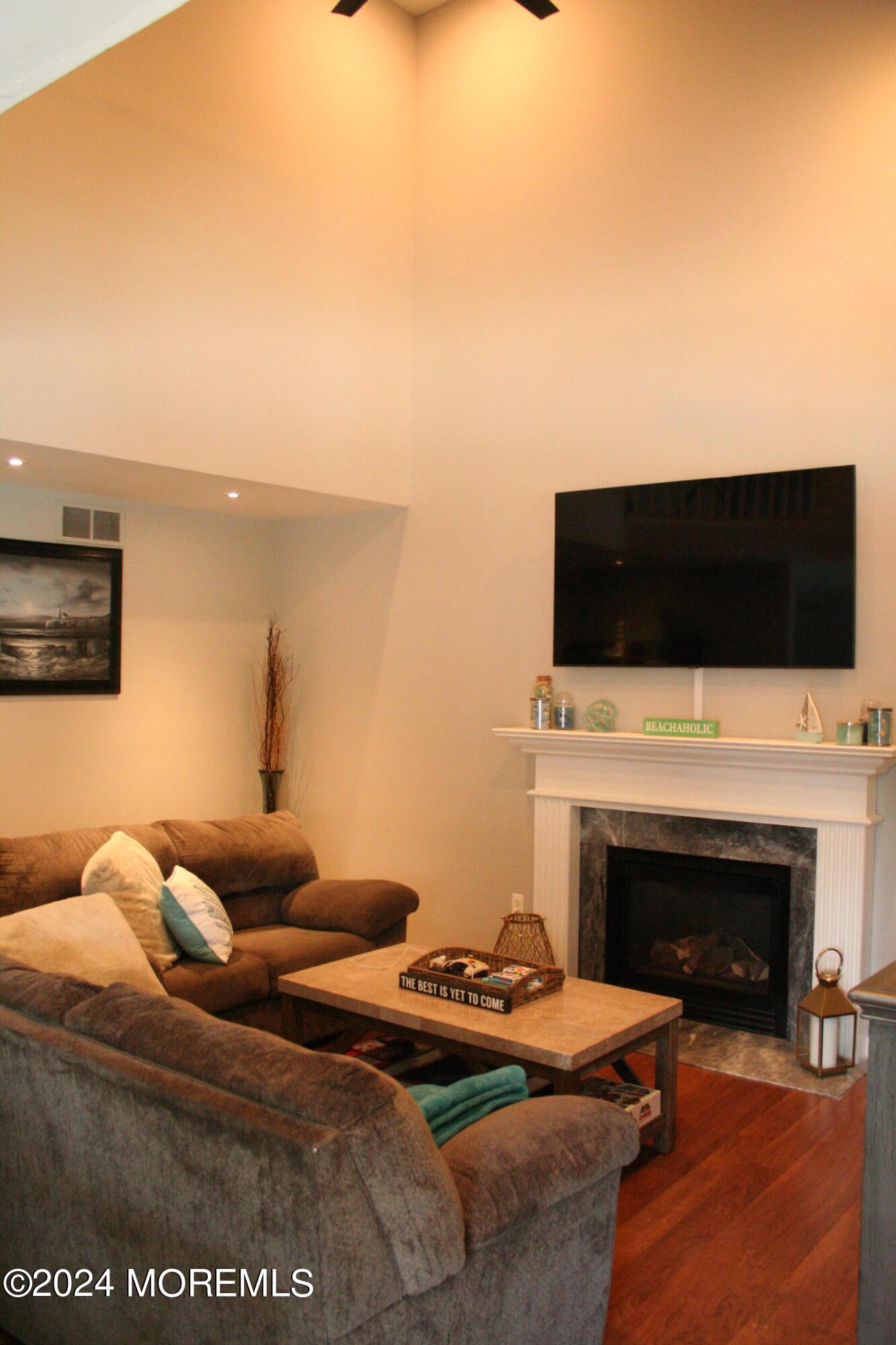 307 Lighthouse Drive Manahawkin, NJ 08050 - Photo 14 of 47 a living room with furniture a fireplace and a flat screen tv