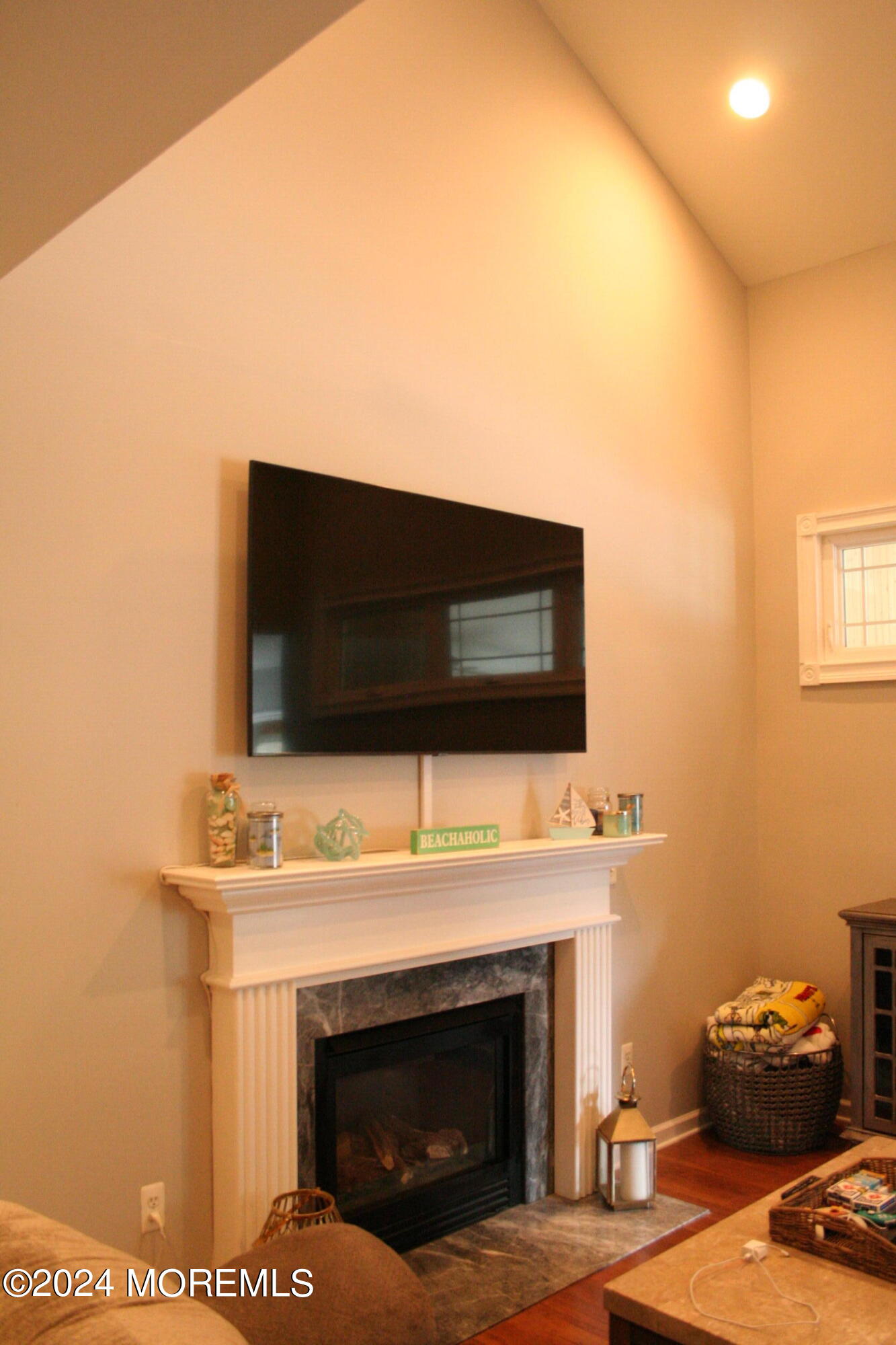 307 Lighthouse Drive Manahawkin, NJ 08050 - Photo 15 of 47 a living room with a fireplace and a flat screen tv