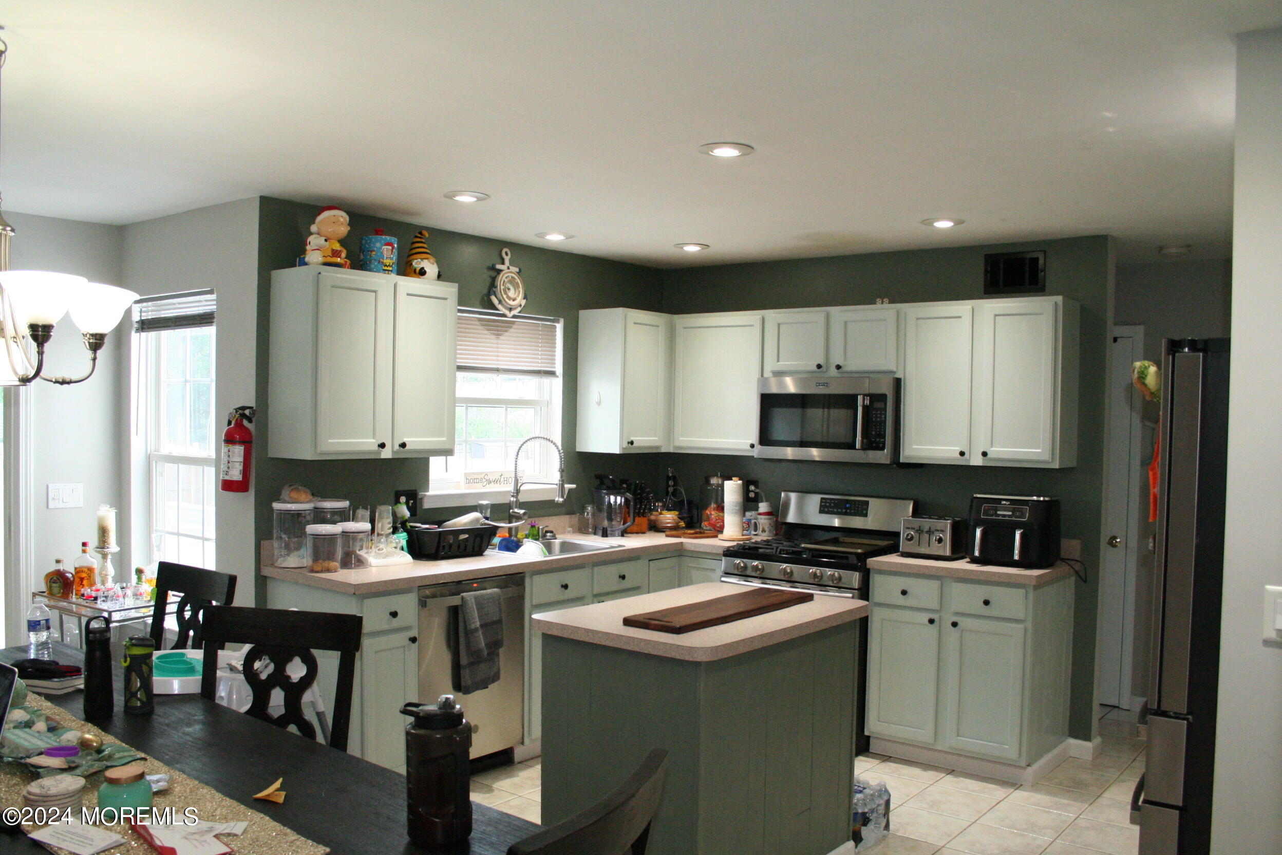 307 Lighthouse Drive Manahawkin, NJ 08050 - Photo 17 of 47 a kitchen with a sink stove and cabinets